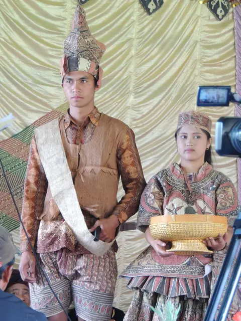 Dressed in folk costumes made from tree barks to welcome guests